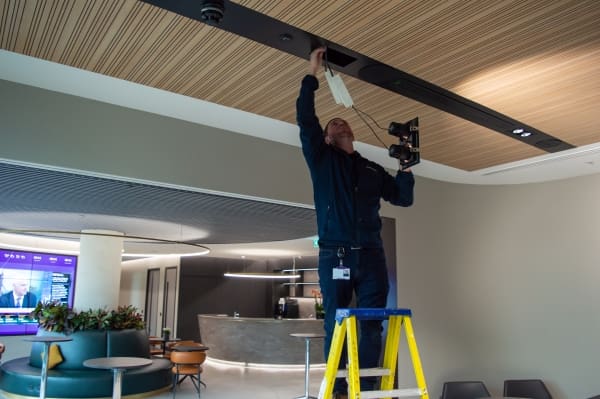 GBBSM Mobile Maintenance Engineer, Danny Jennings changing a lighting fixture at Peel Hunt, 100 Liverpool Street.