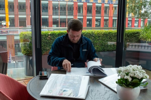 GBBSM Mobile Maintenance Engineer, Danny Jennings checking the log books at Peel Hunt, 100 Liverpool Street.